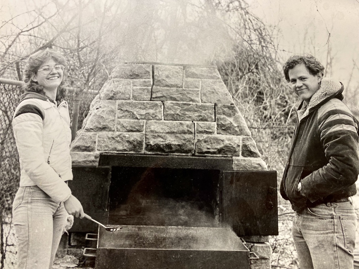 In this 1980s photo, Cathy (Schmidt) Bean, '84, and then EIC Program Manager Mike Hayes, '78, make maple syrup on campus.