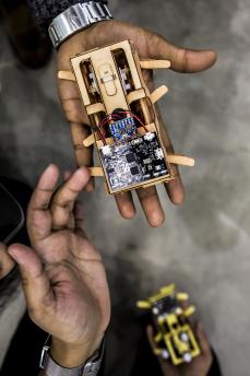 Hand holding a computer part with a circuit board