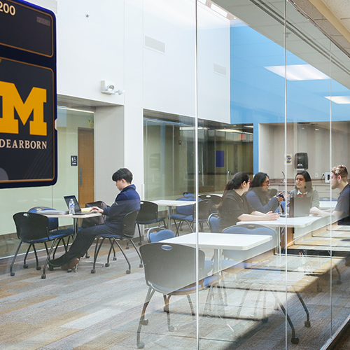 Students in a conference room at tables studying and chatting.