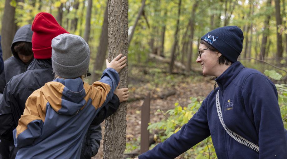 Students feel bark of the tree as staff guide leads