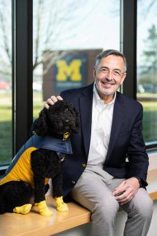 Chancellor Grasso with Moses, the university's therapy dog
