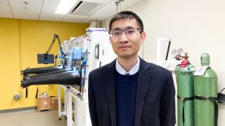 Assistant Professor of Mechanical Engineering Lei Chen stands for a portrait in his lab